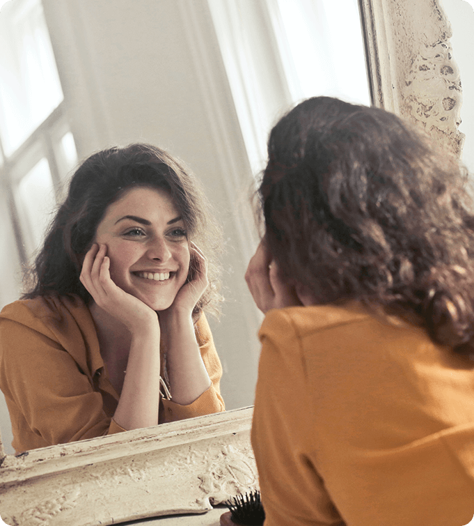 a photo of a woman looking at herself in the mirror